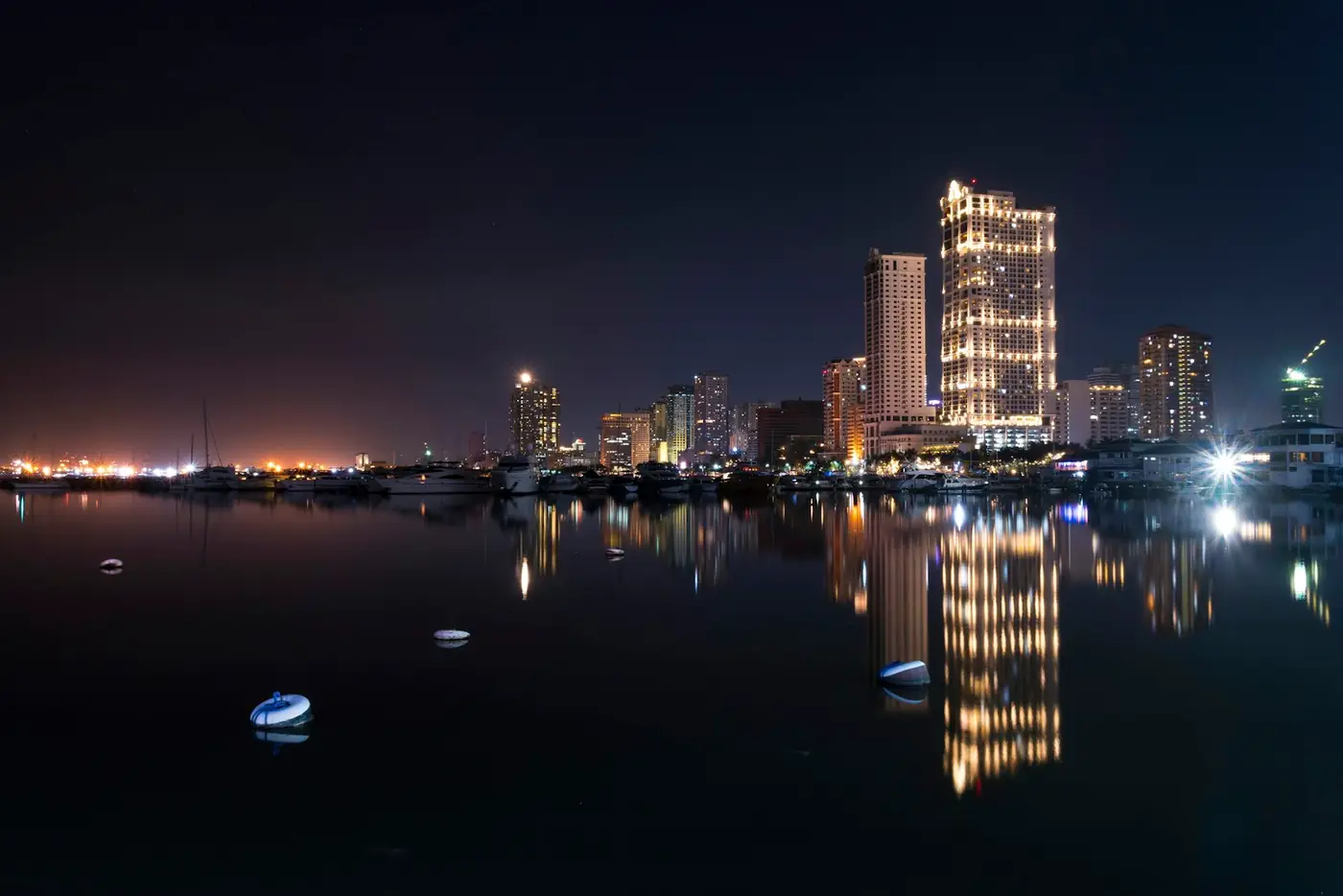 Manila Bay at night, city lights reflected on the water
